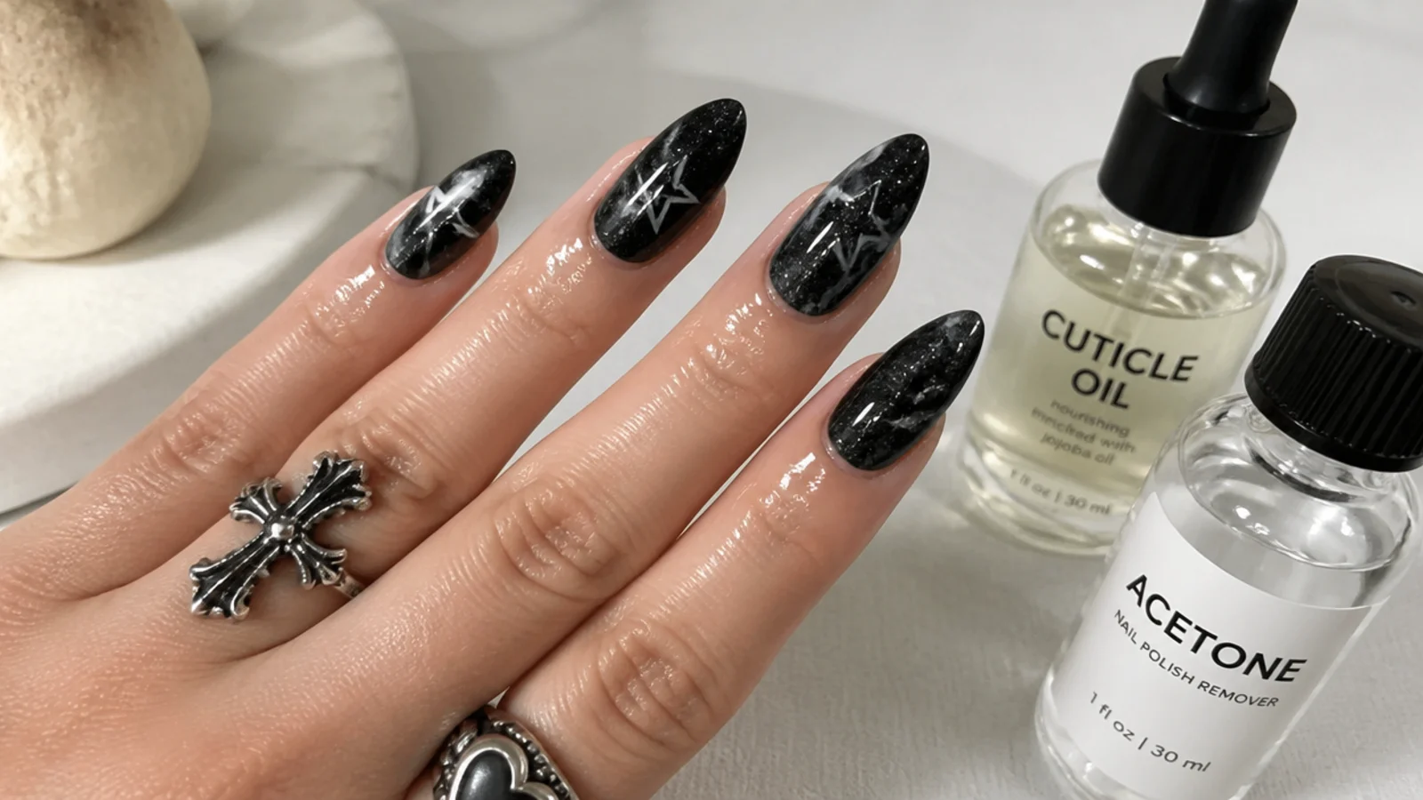 A well-sealed black emo manicure with cuticle oil and acetone for removal
