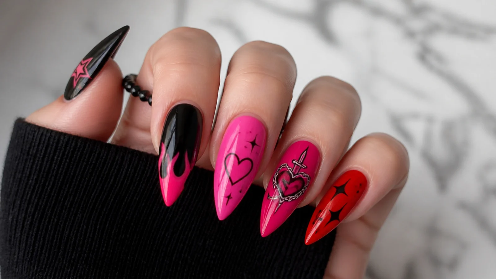 Swatches of black, hot pink and red emo nail colors with motif samples