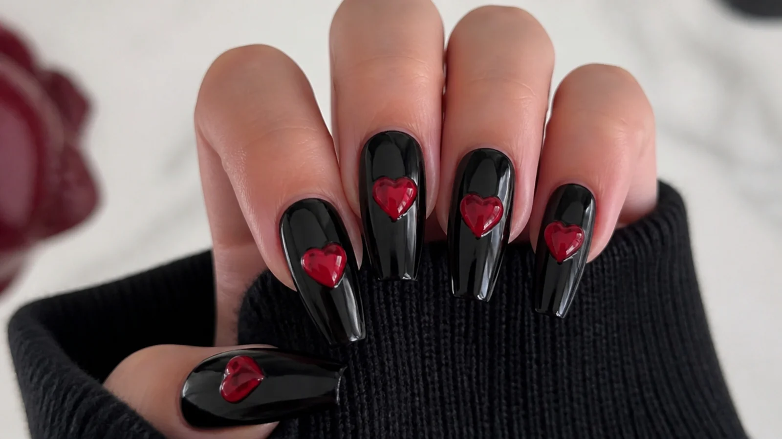 Black nails with glossy cherry red hearts, emo Y2K accents