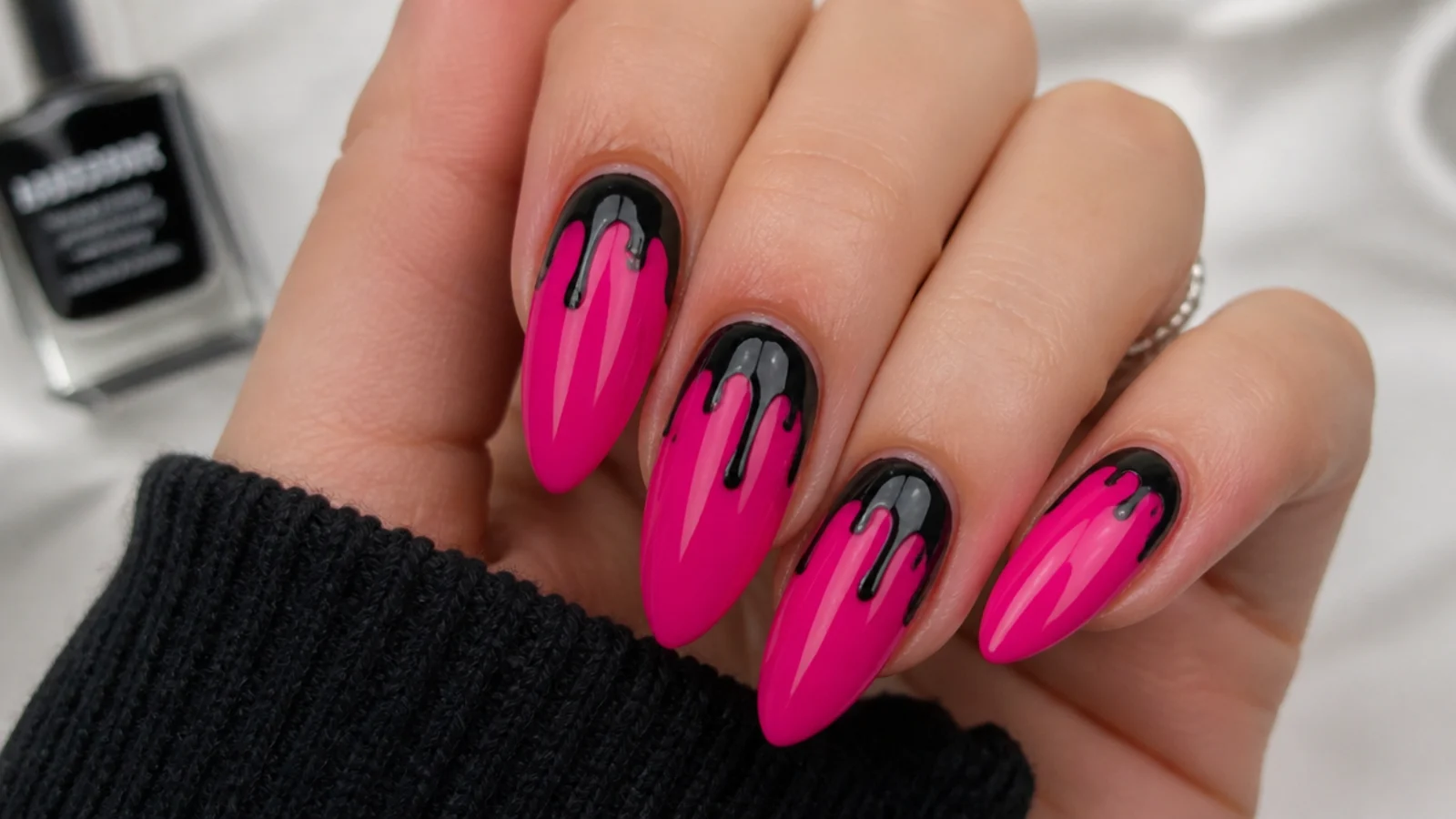 Hot pink nails with black paint drips running from the cuticle, emo style