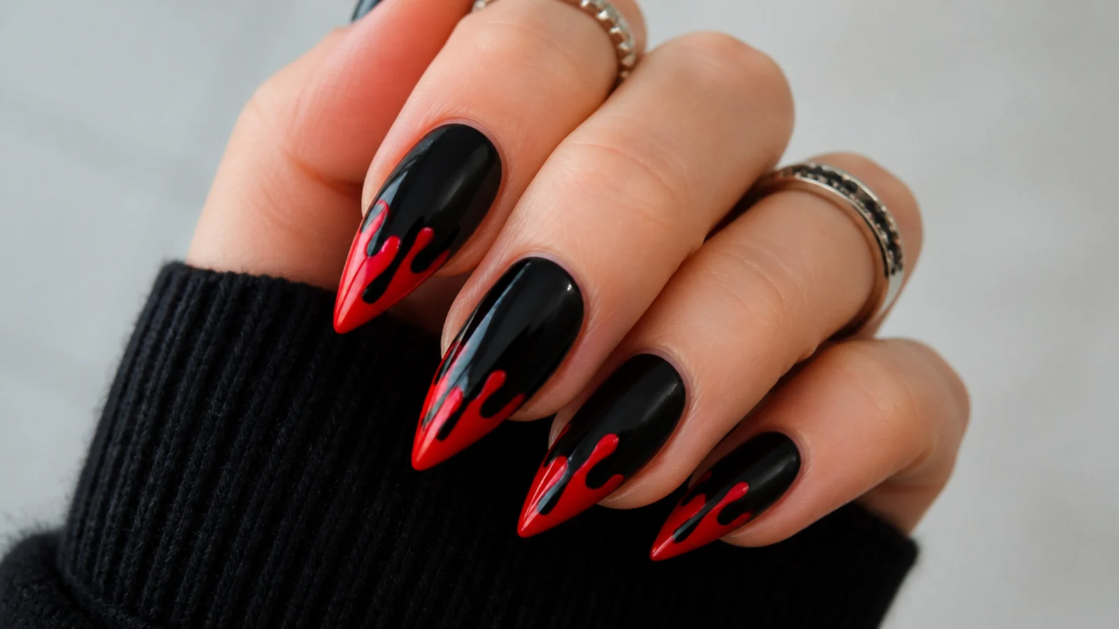 Black nails with cherry red drips running from the tips, emo Y2K style