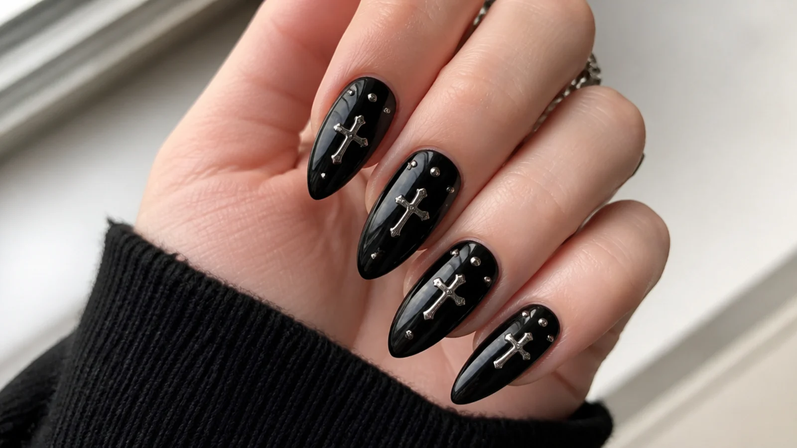 Black nails with small silver cross charms and studs, emo Y2K style
