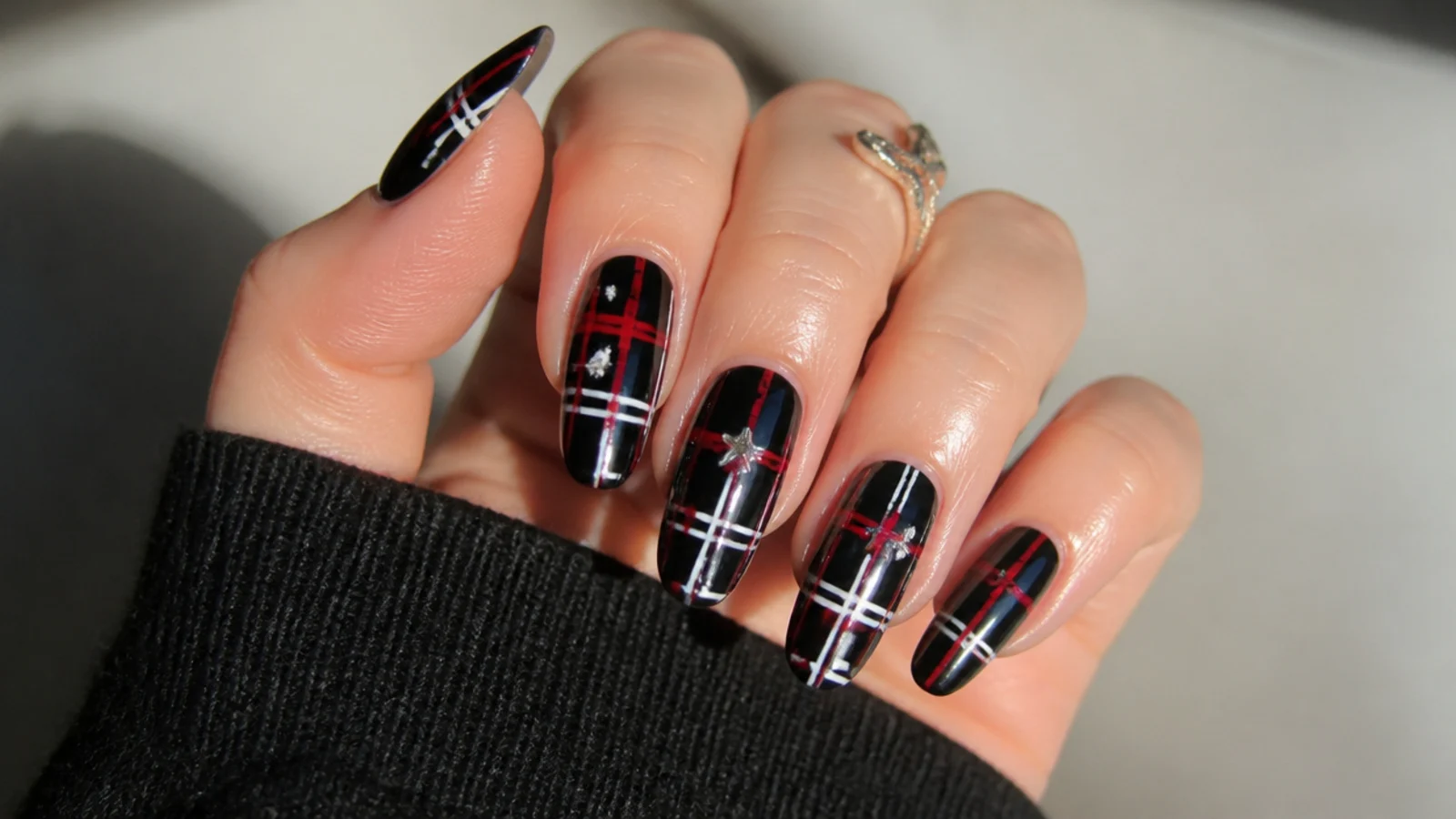 Black nails with red and white plaid pattern, emo punk Y2K style