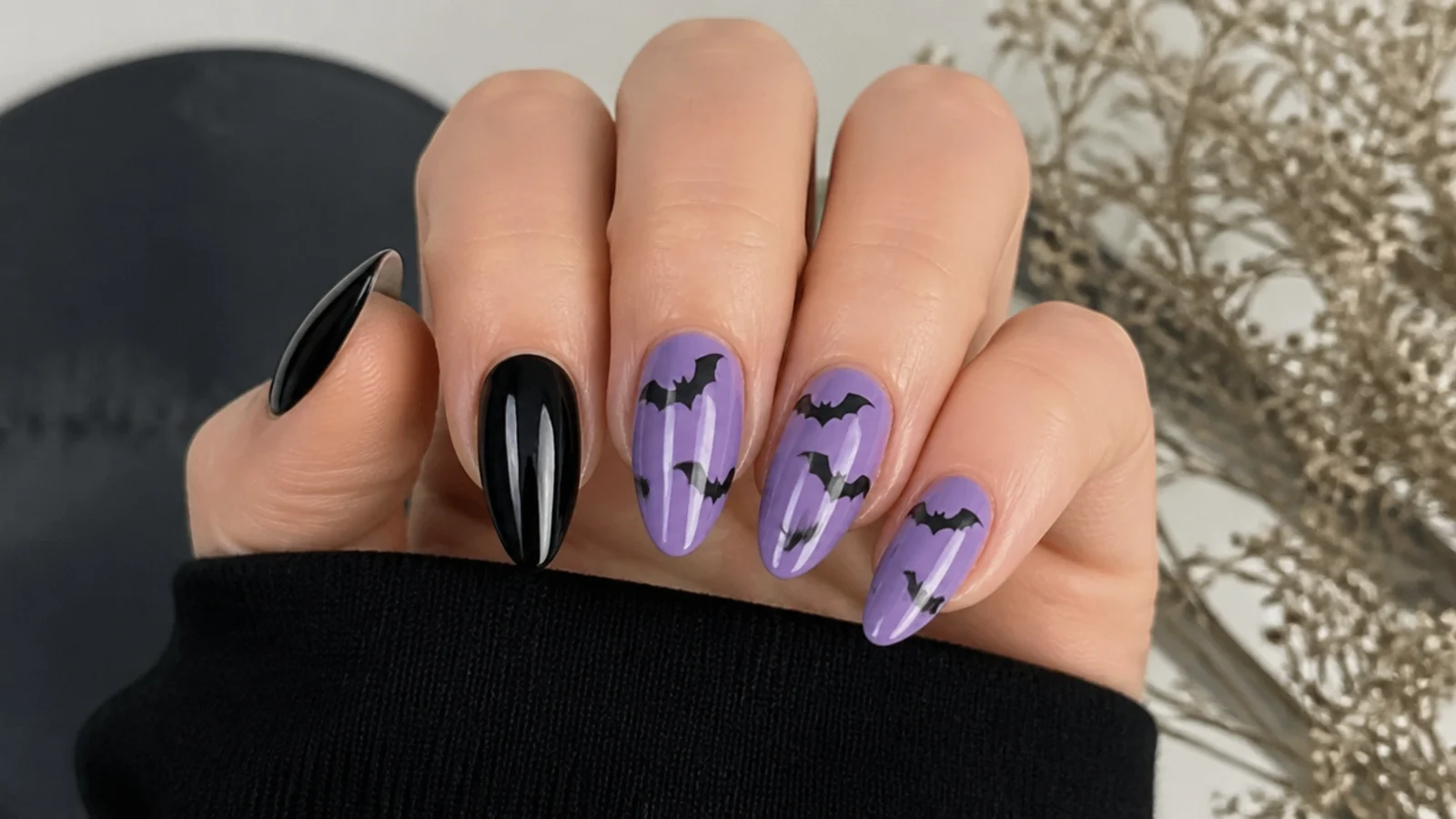Purple and black nails with small black bat silhouettes, emo Y2K style