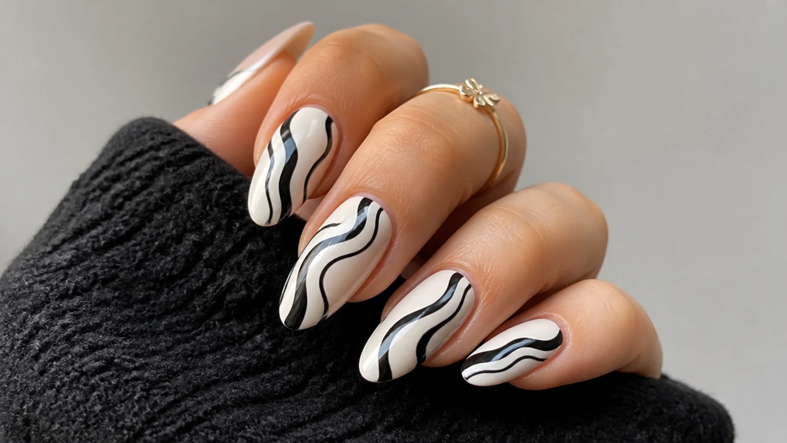 White nails with black wavy swirl lines, emo Y2K style