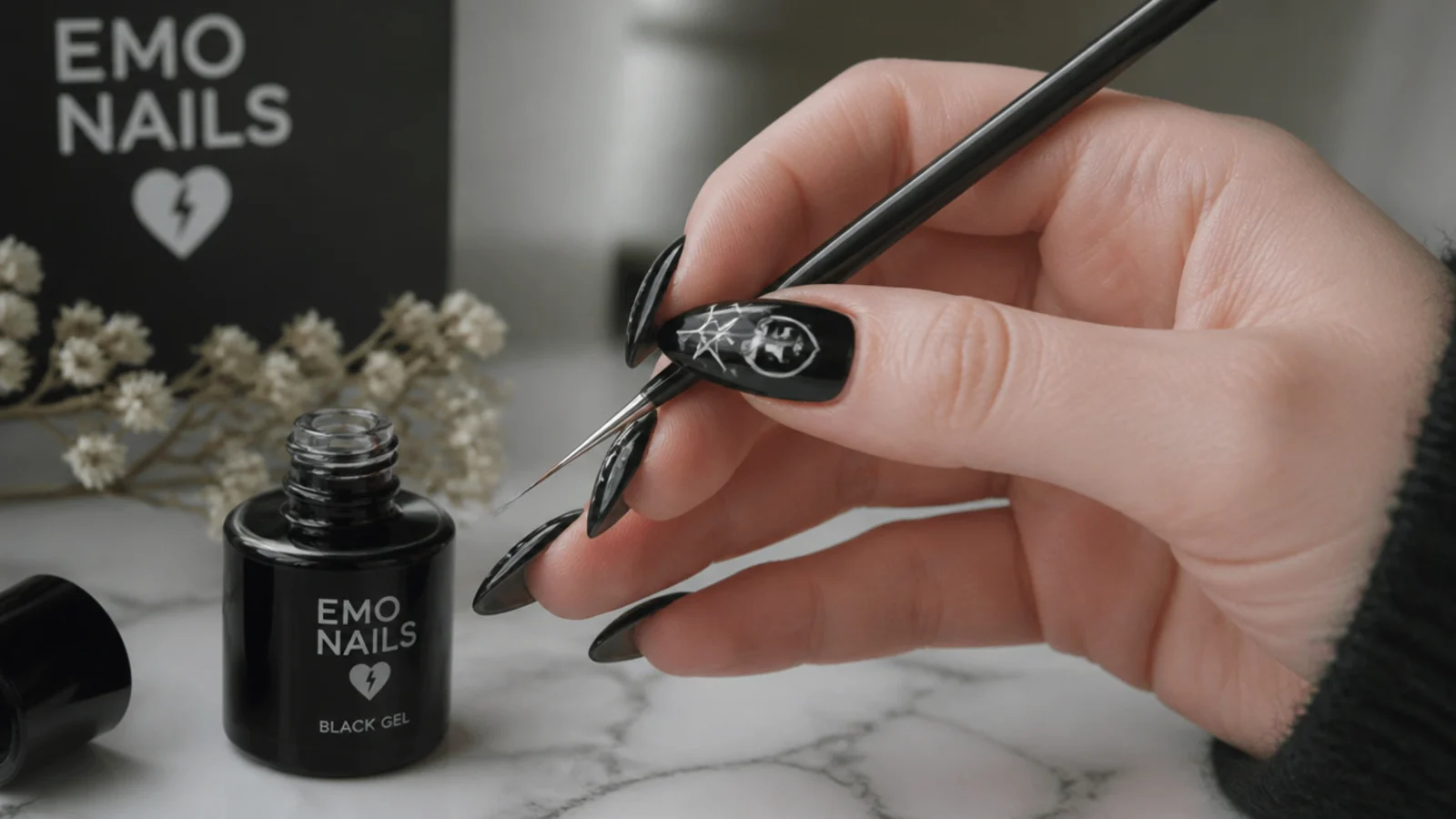 Emo nail supplies with a black base and fine liner brush mid-design