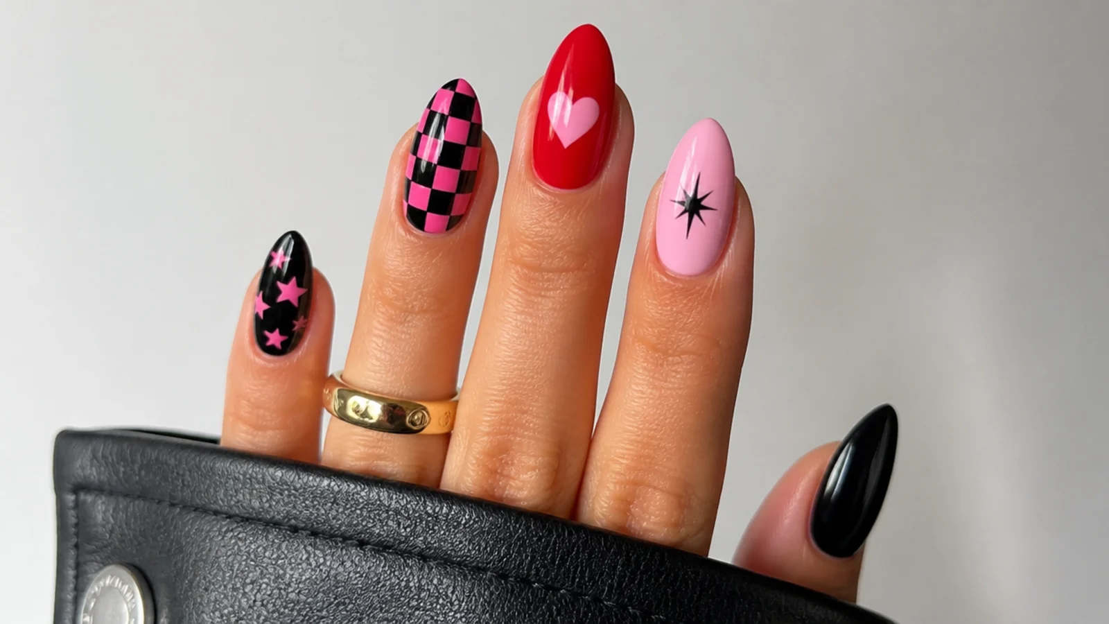 Swatches of black, hot pink and red with checker, heart and star motifs