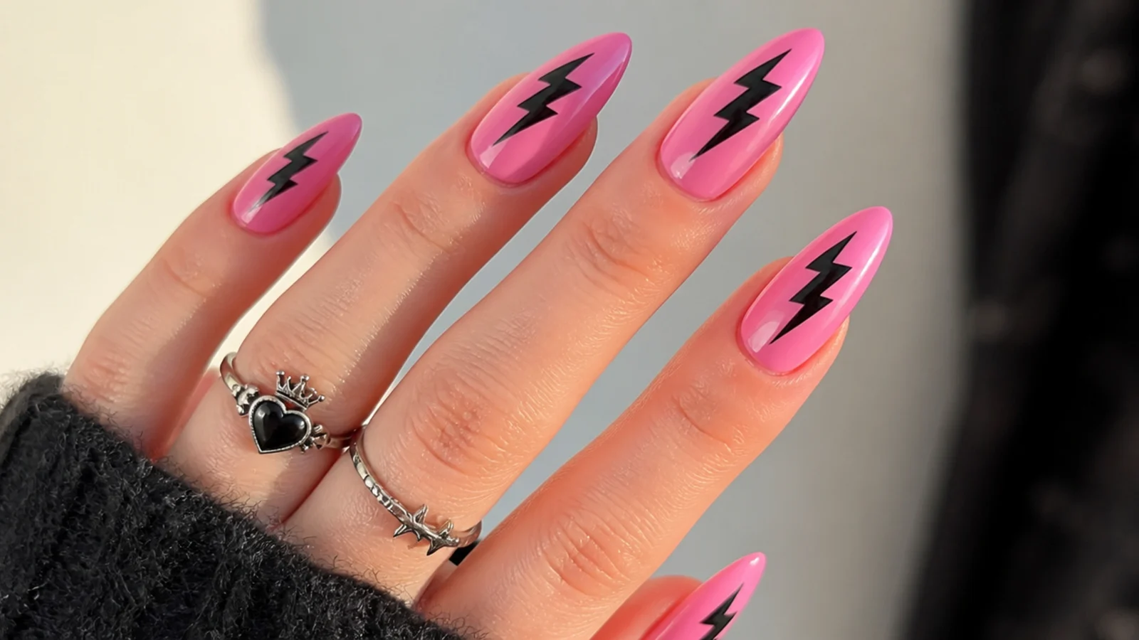 Pink emo nails with a black lightning bolt down the center