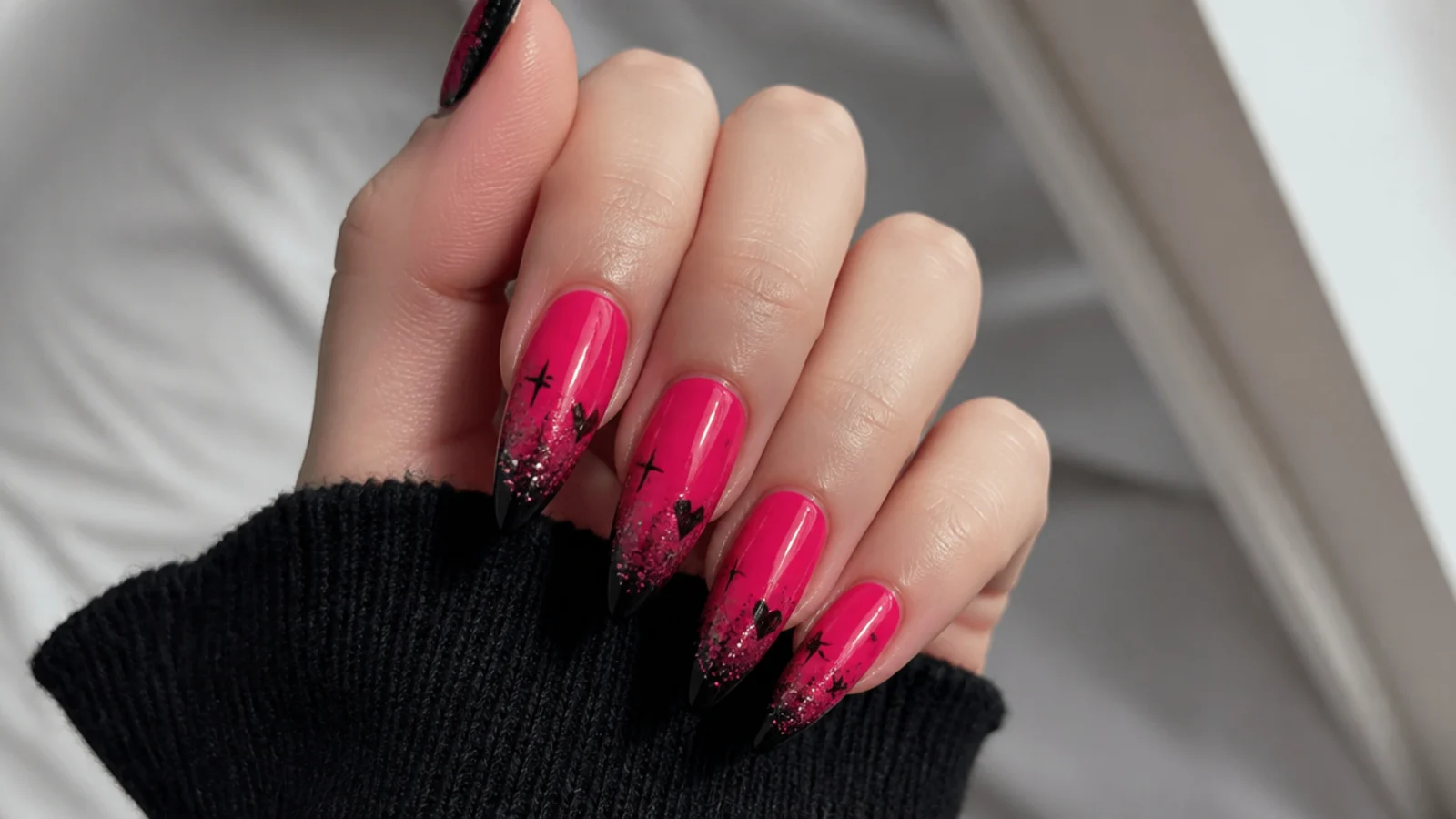 Hot pink emo nails with black tips and pink glitter gradient