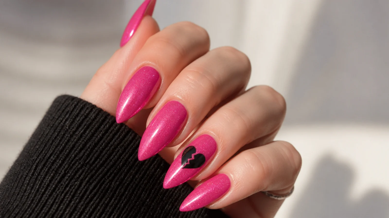 Pink emo nails with a black cracked broken-heart motif on accent nail