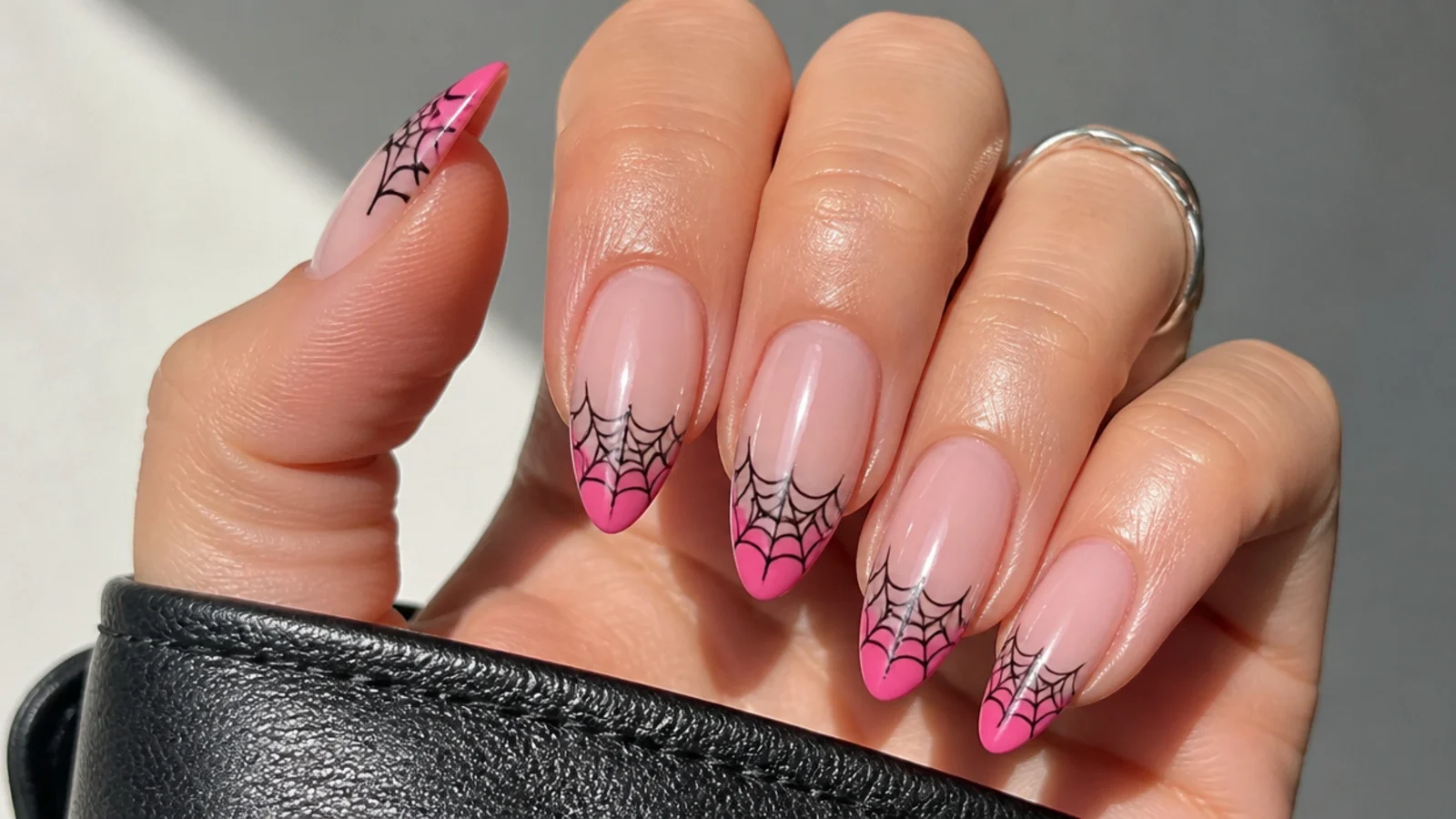 Pink French tip emo nails with fine black spiderweb over the tip