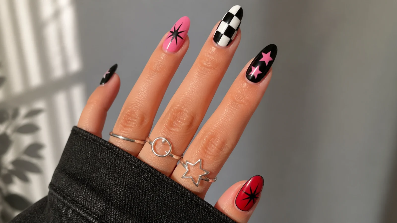 Swatches of pink, black and red with emo checkerboard and star motifs
