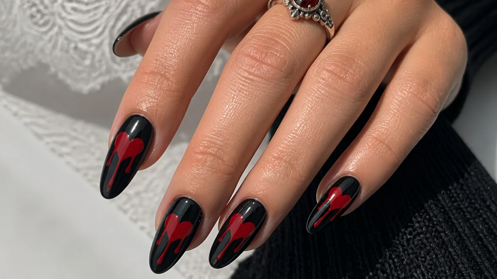 Black emo nails with dripping red hearts down the nail