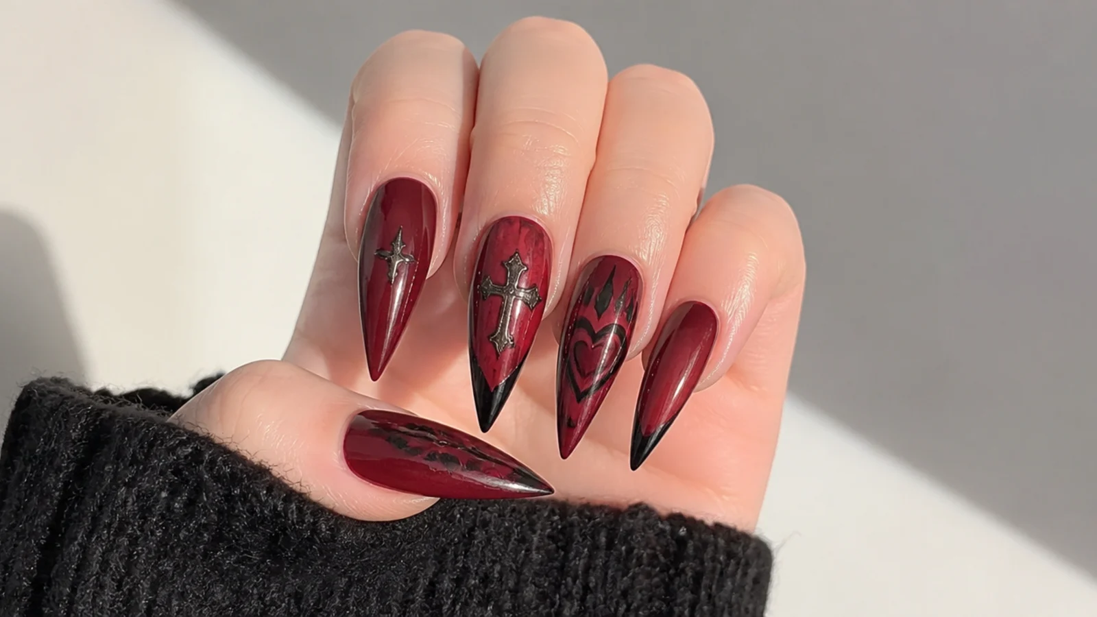 Glossy oxblood red stiletto emo nails with sharp points