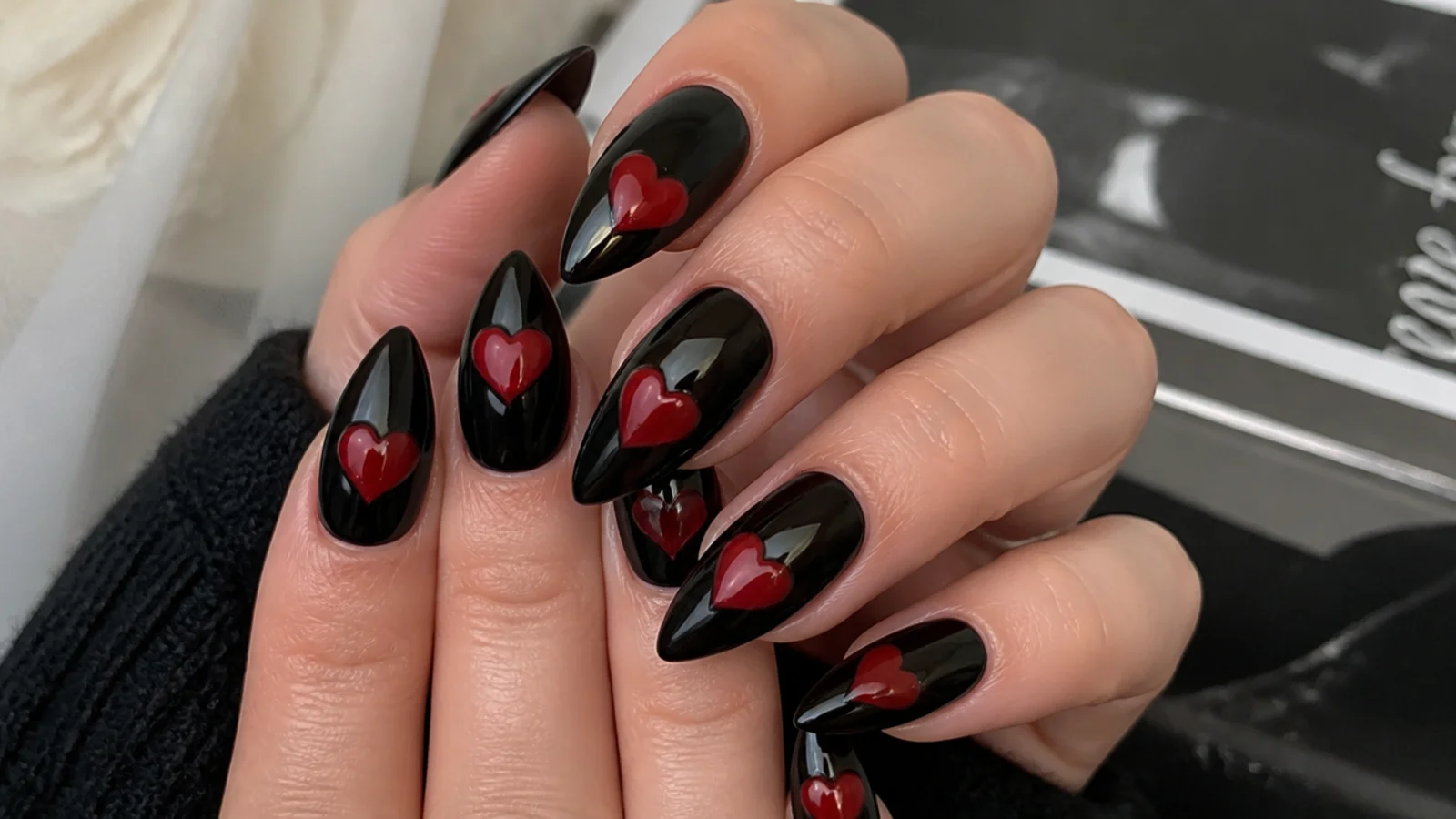 Glossy black emo nails with bold cherry-red hearts