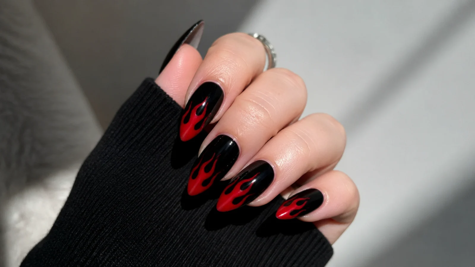 Black emo nails with red flames licking up from the tips