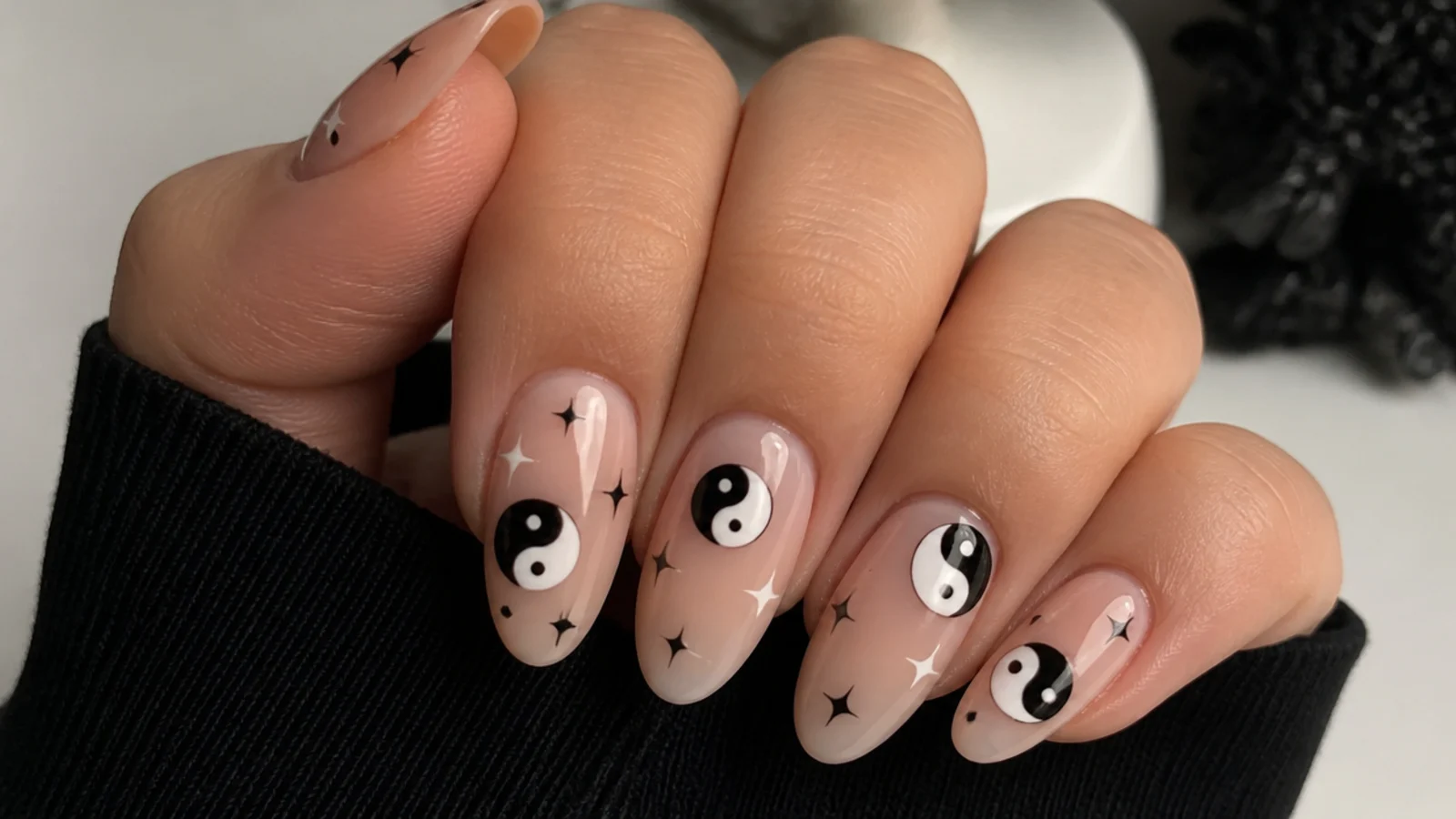 Nails with black and white yin-yang symbols in Y2K emo style