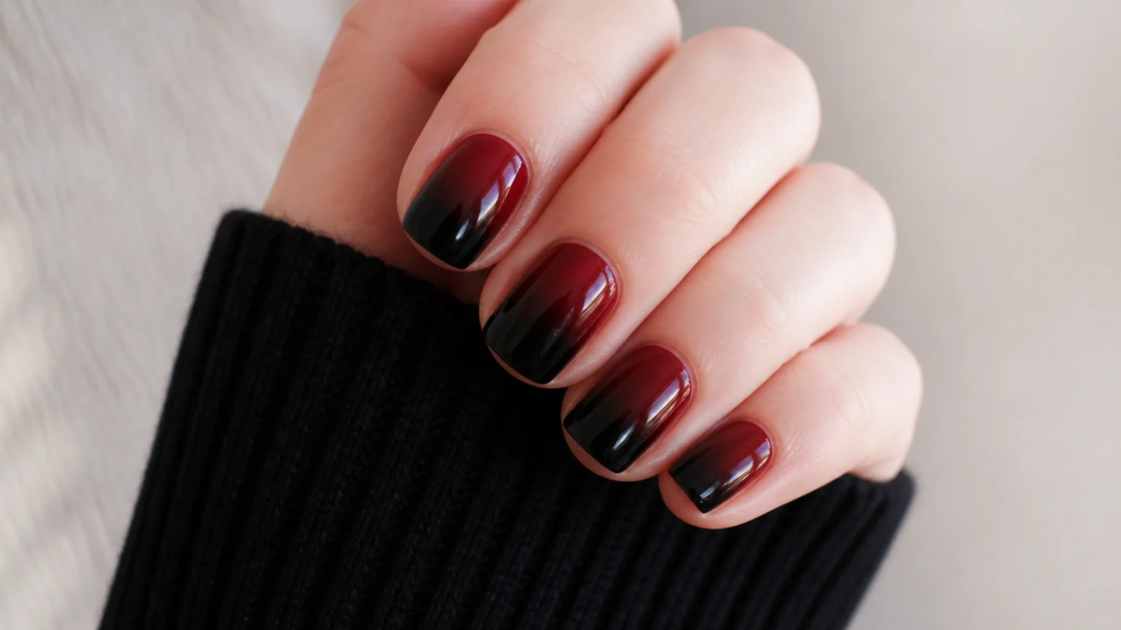 Short nails fading from deep red at the cuticle to black at the tips
