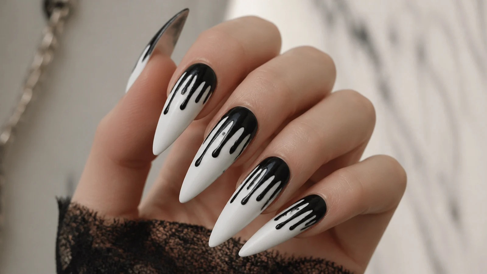 White emo nails with black paint drips running down from the tips