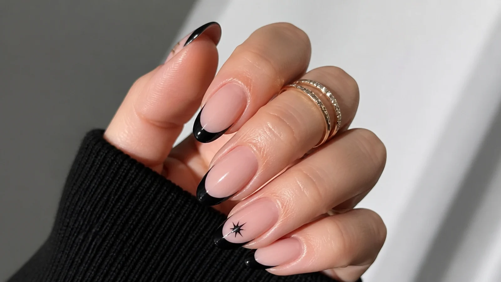 Nude emo nails with crisp black French tips