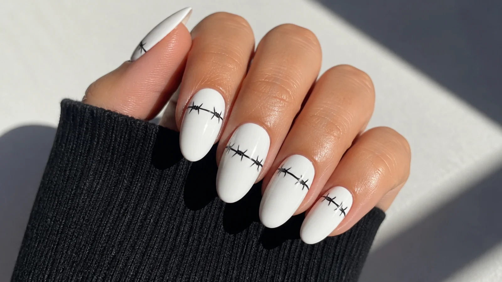 White emo nails with a thin black barbed-wire line across each nail
