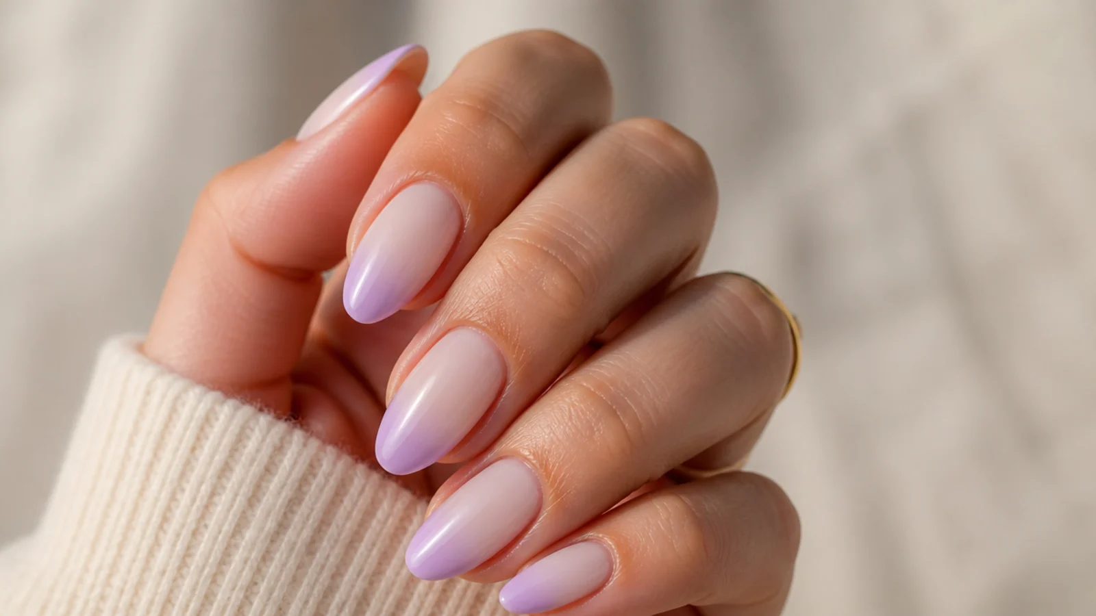 Almond nails with a soft lavender ombre French tip fading into a milky white base