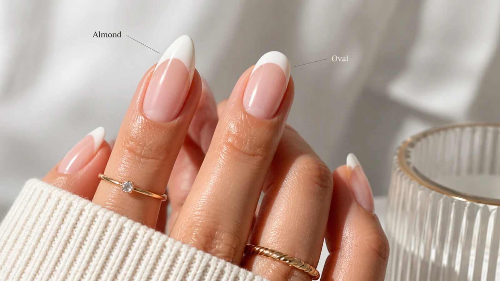 Almond and oval nail shapes side by side, both with white French tips on a nude base
