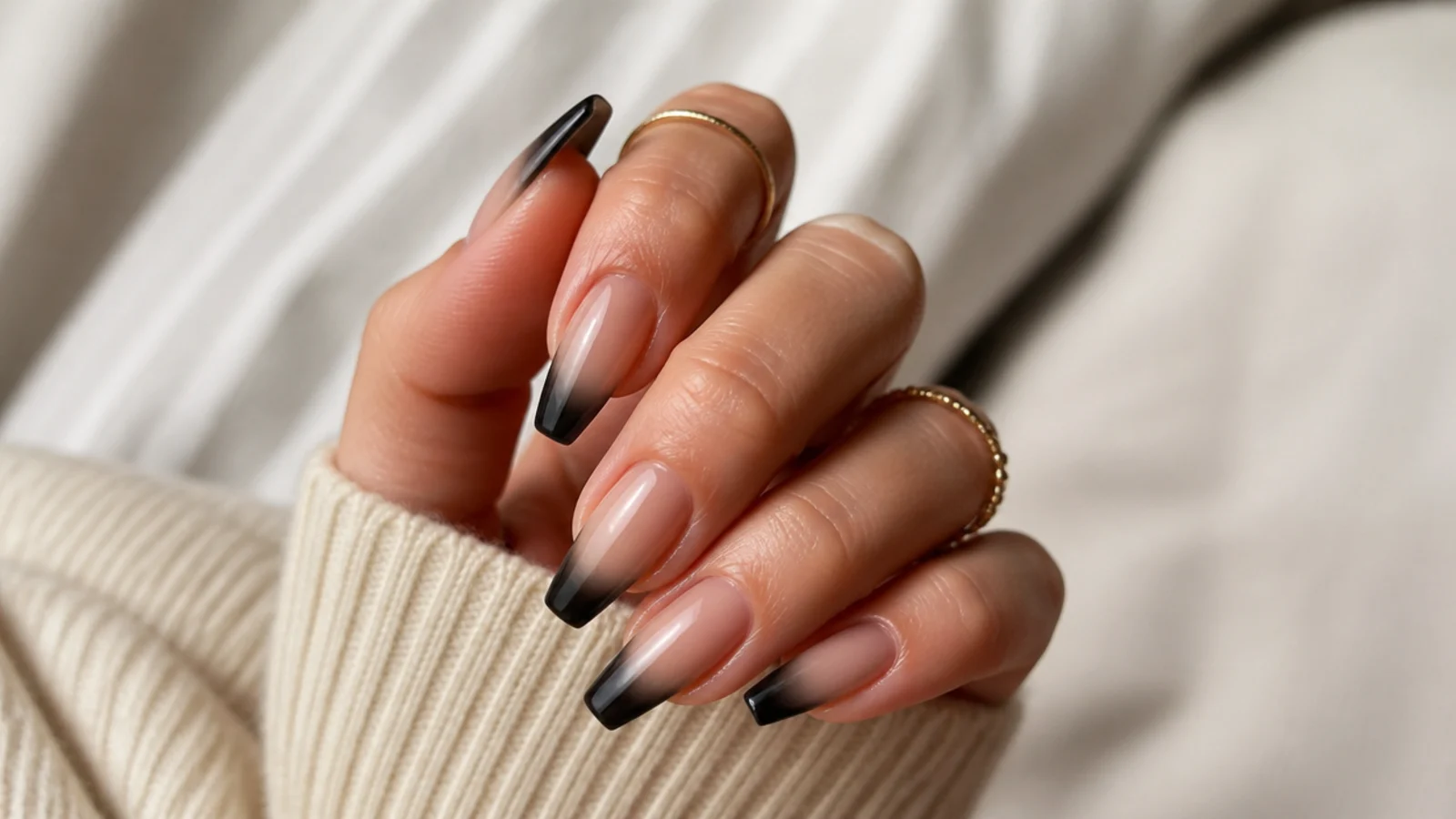 Coffin nails with a smoky black French tip fading softly up into a sheer nude base