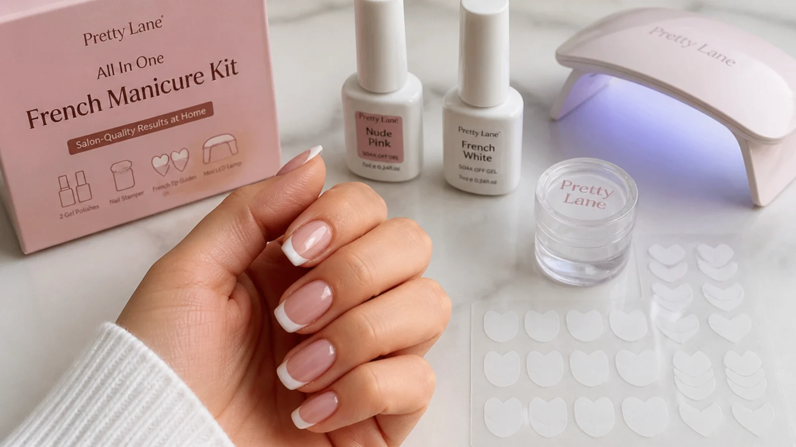 All in one French manicure kit with white and nude gel bottles, stamper, guide stickers and a mini LED lamp