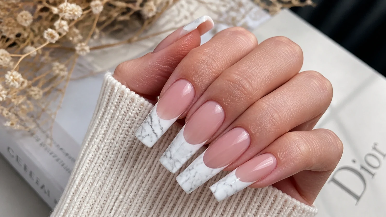 Long coffin nails with white French tips containing fine gray marble veining over a nude base