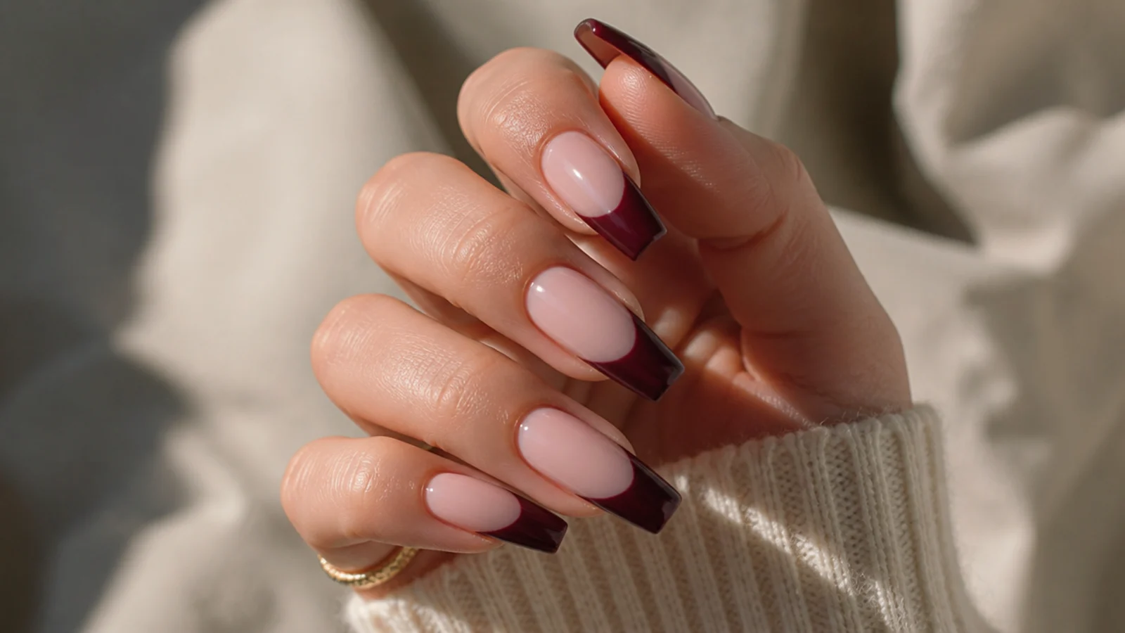 Long coffin nails with deep burgundy wine French tips on a sheer nude base