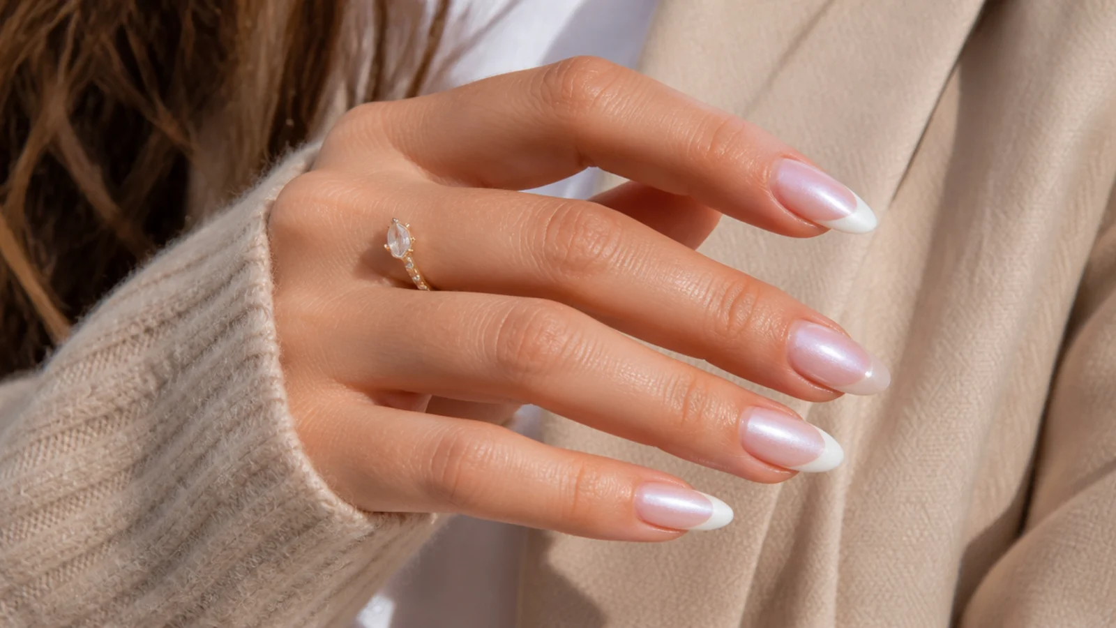 Medium almond nails with pearlescent glazed white French tips catching the light