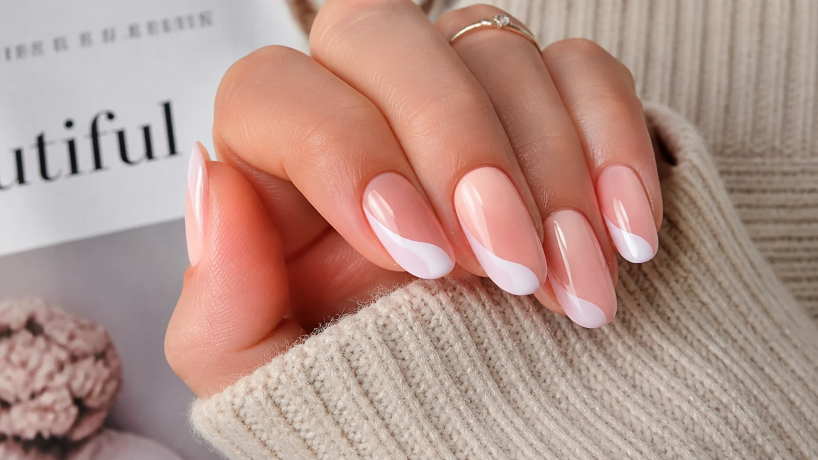 Medium nails with a curved white swirl sweeping across the tip instead of a straight French line