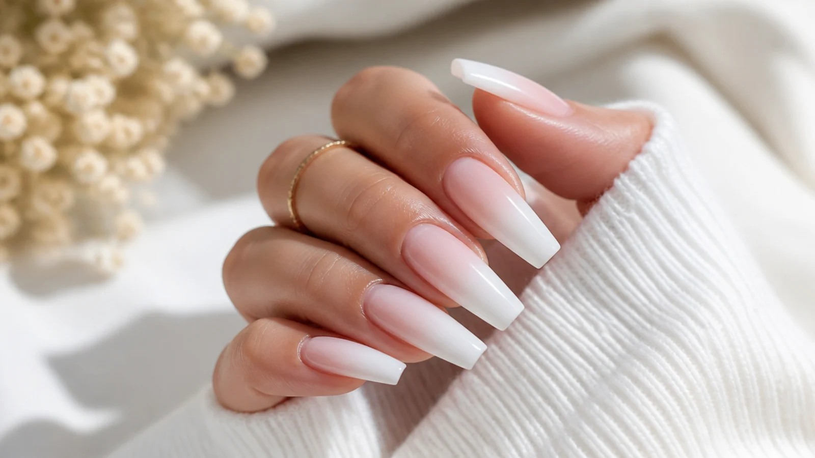 Long coffin nails with a soft white ombre fade blending from tip to nail bed