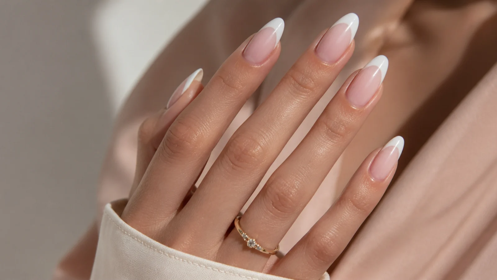 Long almond nails with soft milky white bridal French tips and a glossy top coat