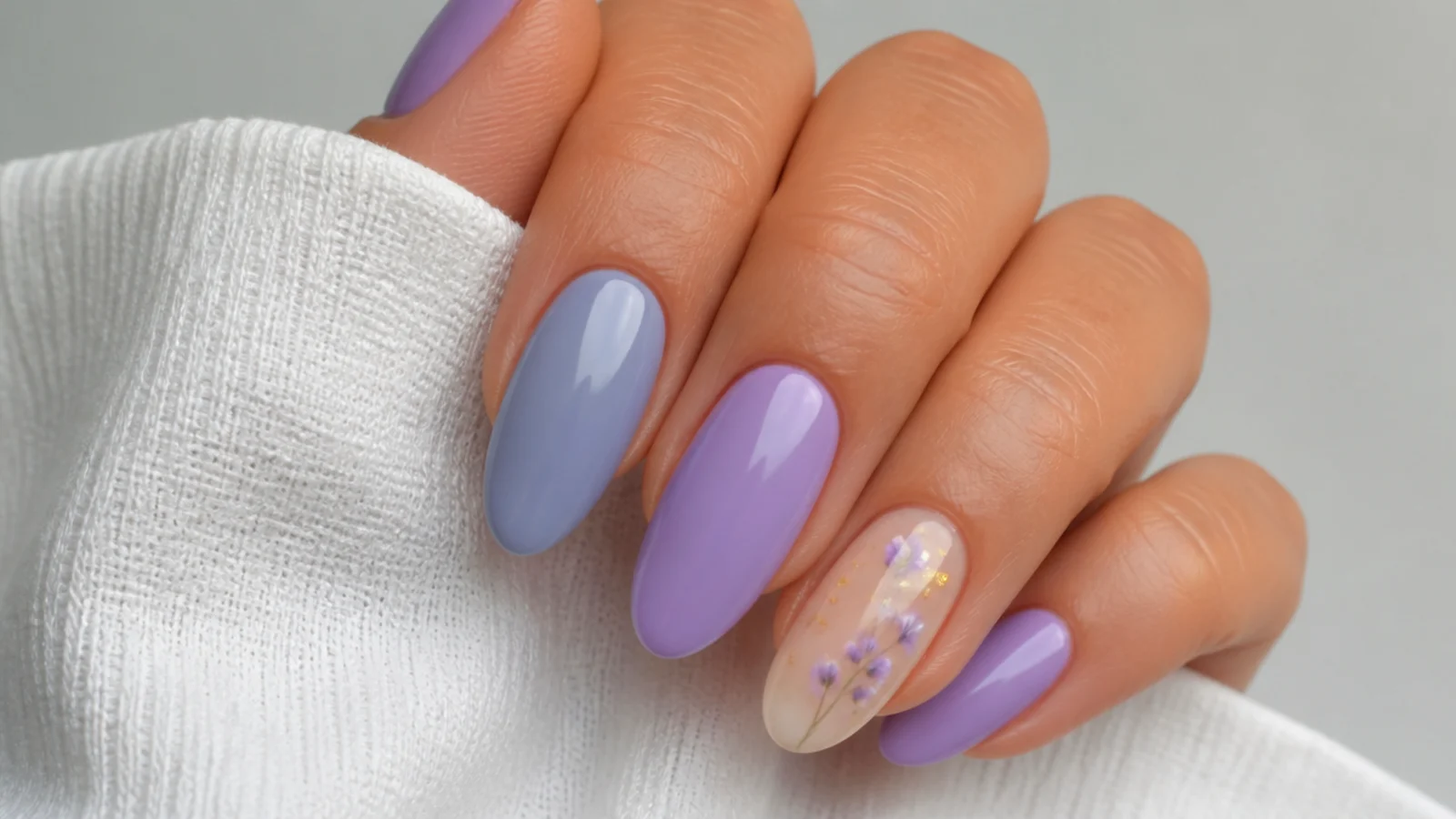 A soft gray-blue lavender nail beside a brighter light purple nail for comparison