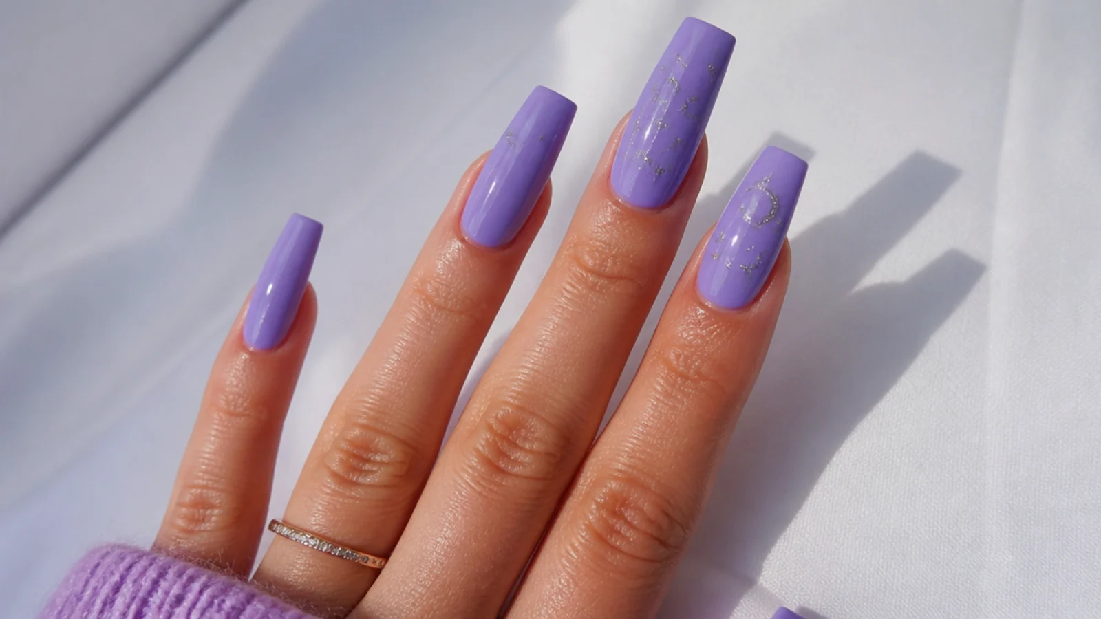 Cool true-lavender acrylic nails in a long coffin shape