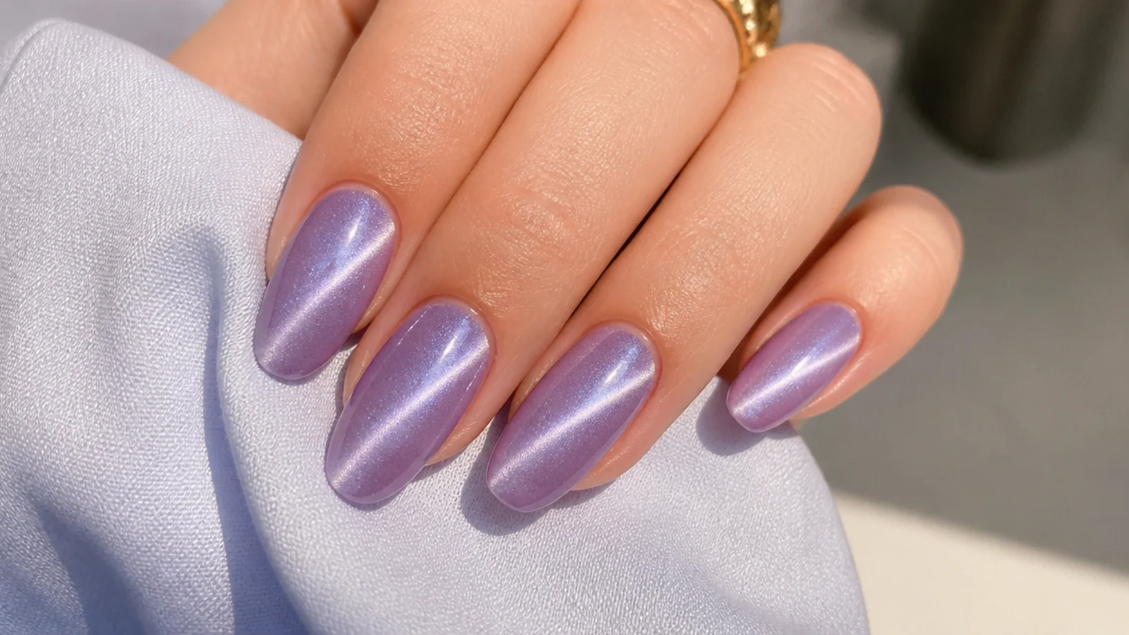 Lavender cat-eye acrylic nails with a bright magnetic light streak