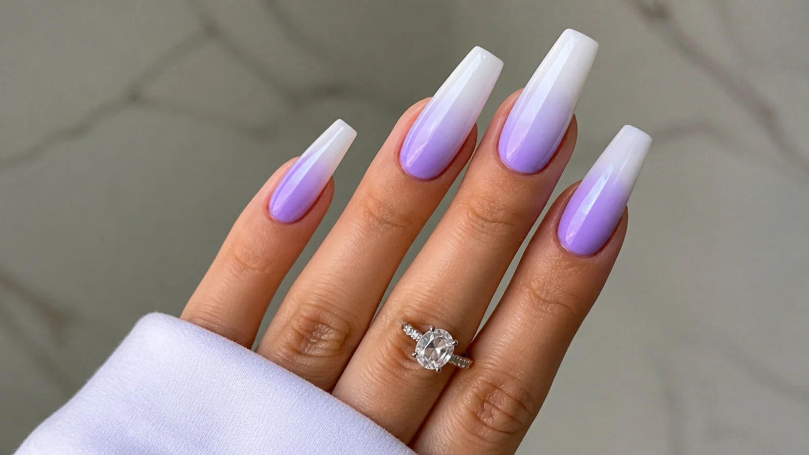 Lavender and white ombre acrylic nails fading from lilac to white tips