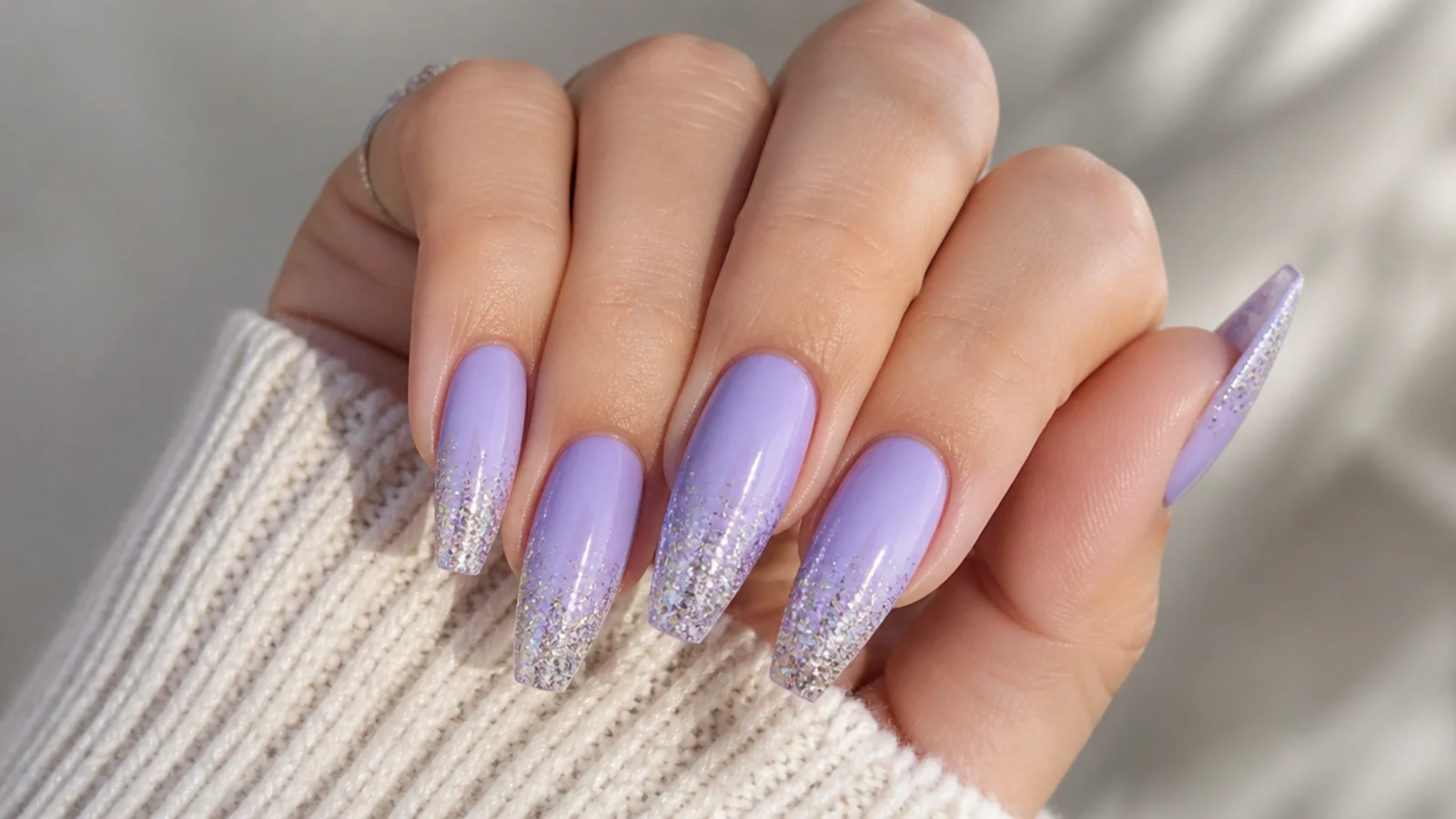 Lavender acrylic nails with silver glitter gradient tips