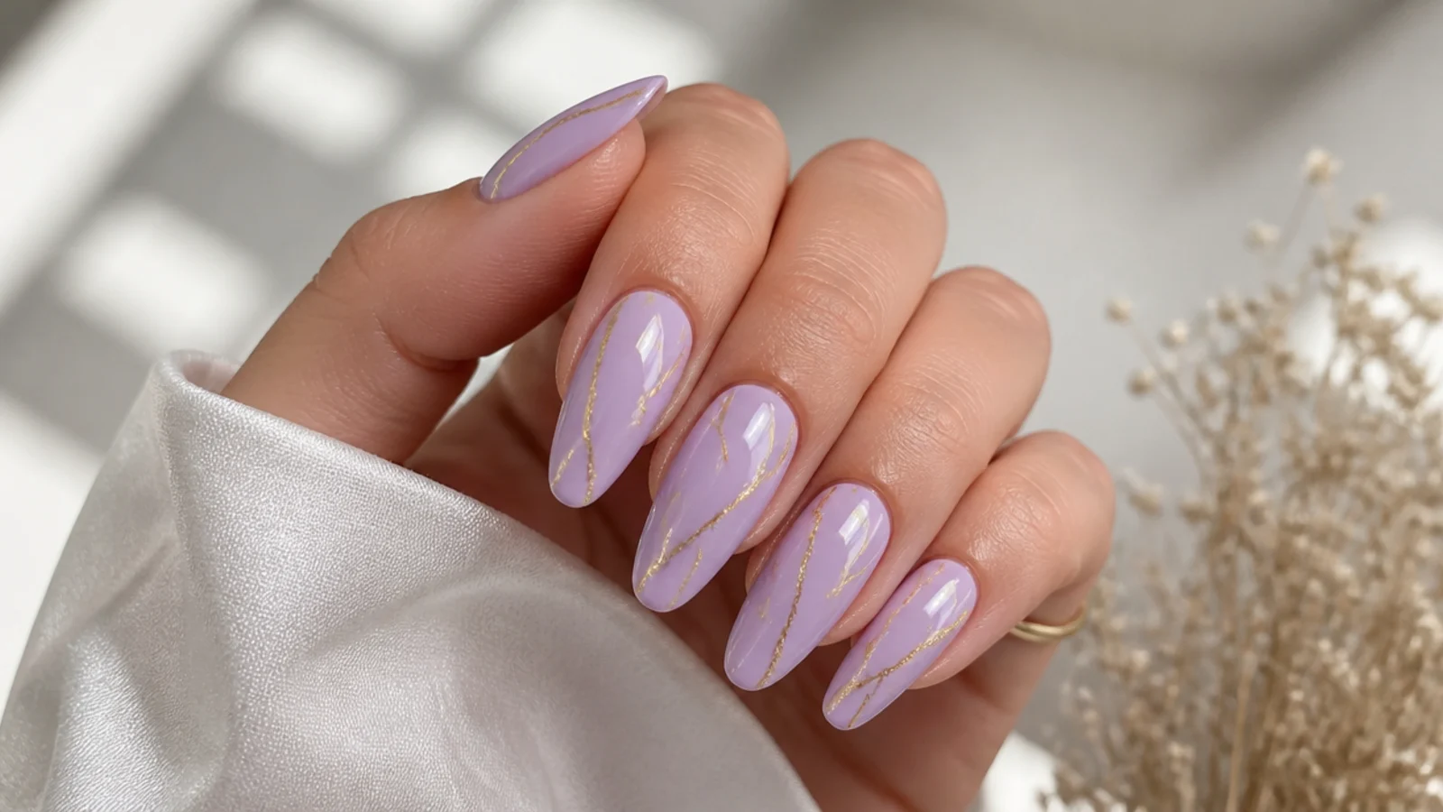 Lavender acrylic nails with thin gold foil line accents