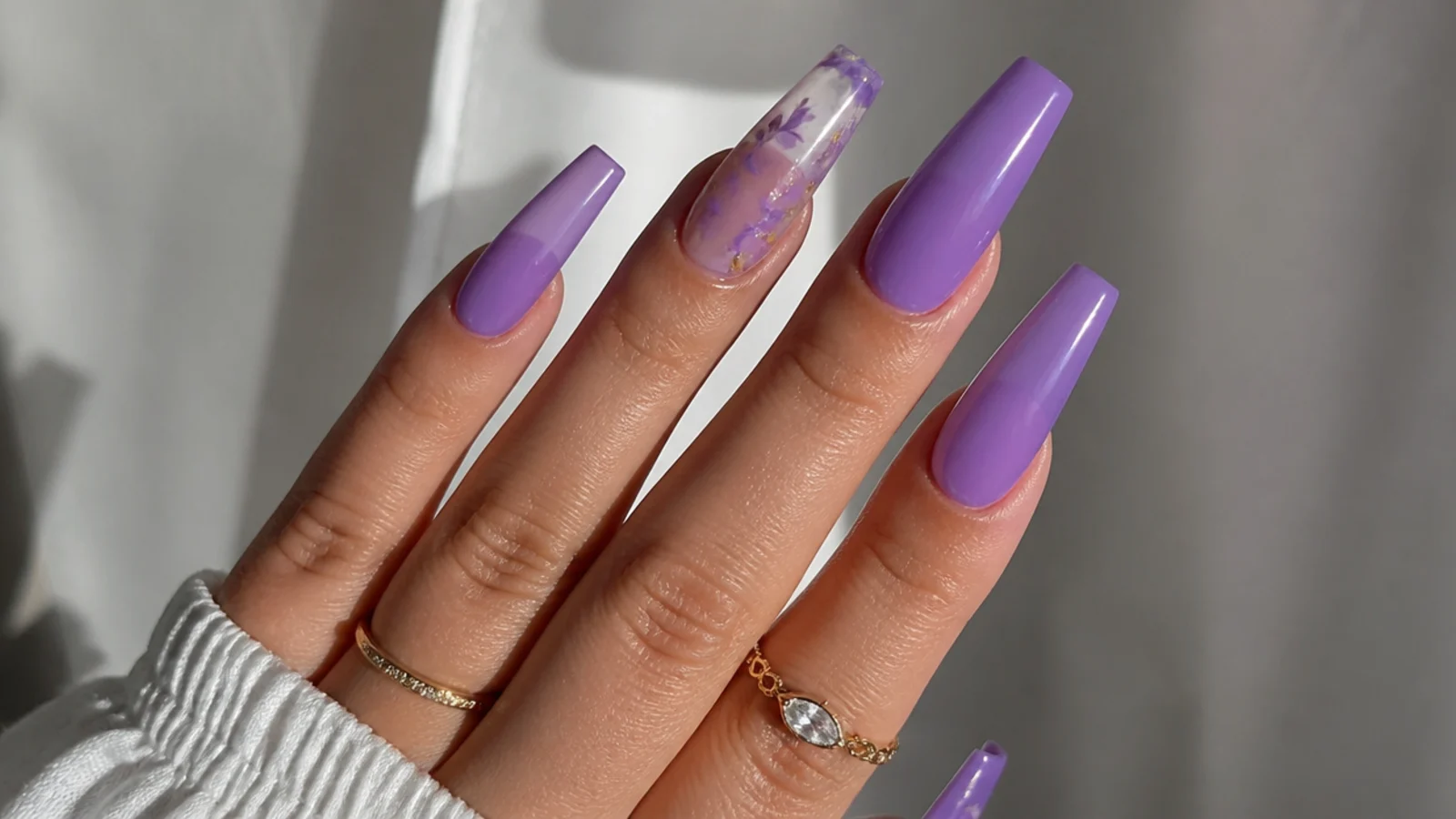 Deep saturated lavender acrylic nails in a long coffin shape