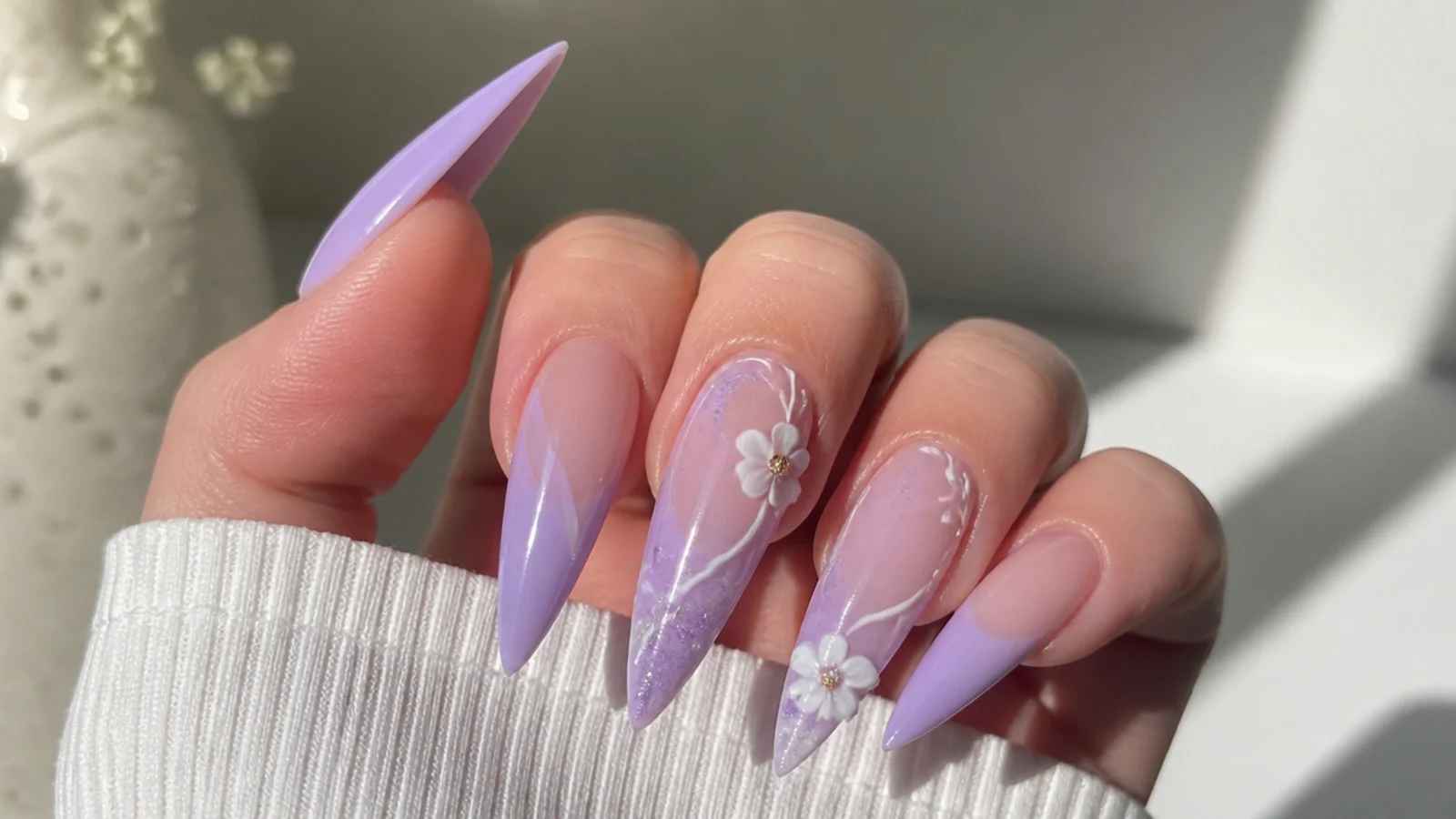Long lavender acrylic nails in a sharp stiletto shape