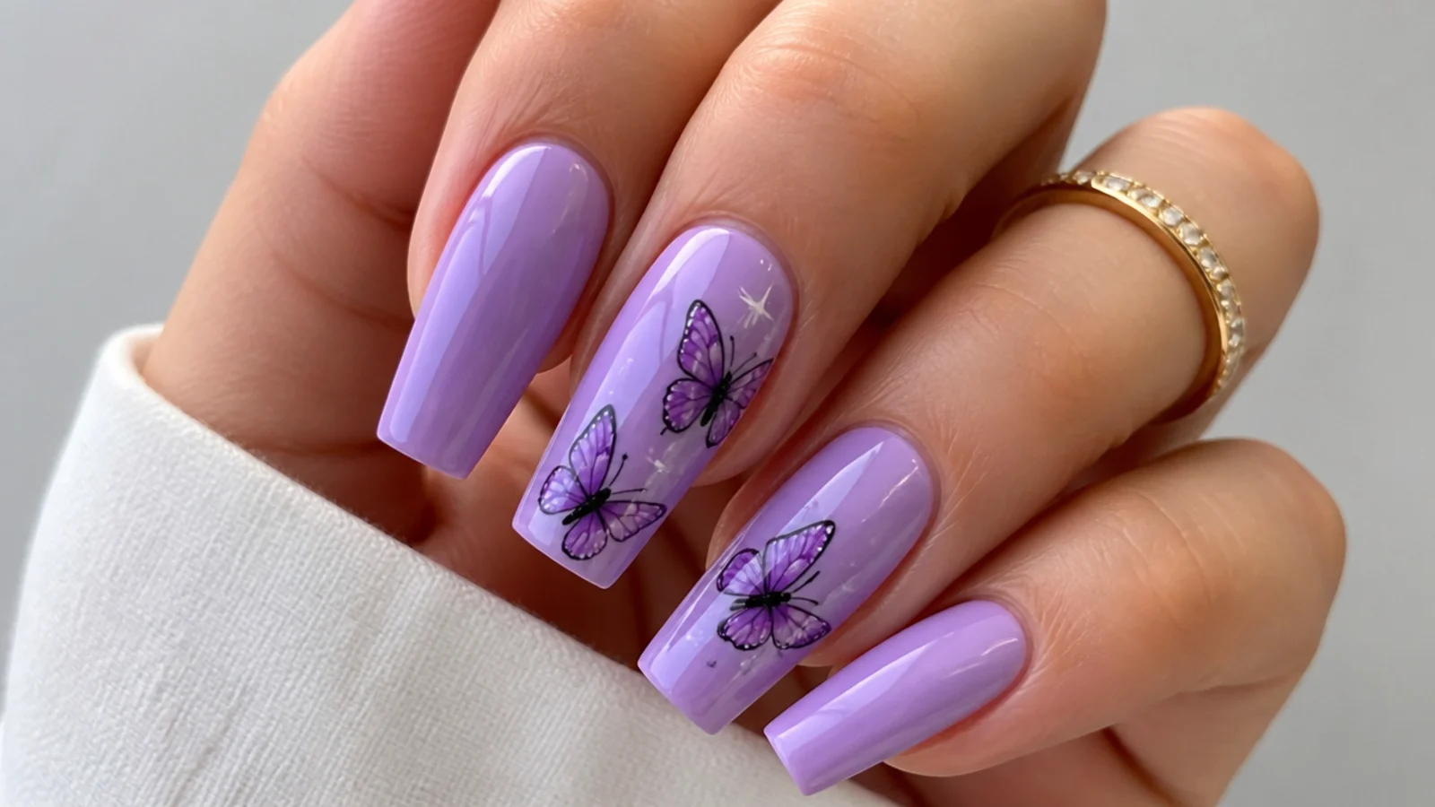 Lavender acrylic nails with hand-painted butterfly accent art