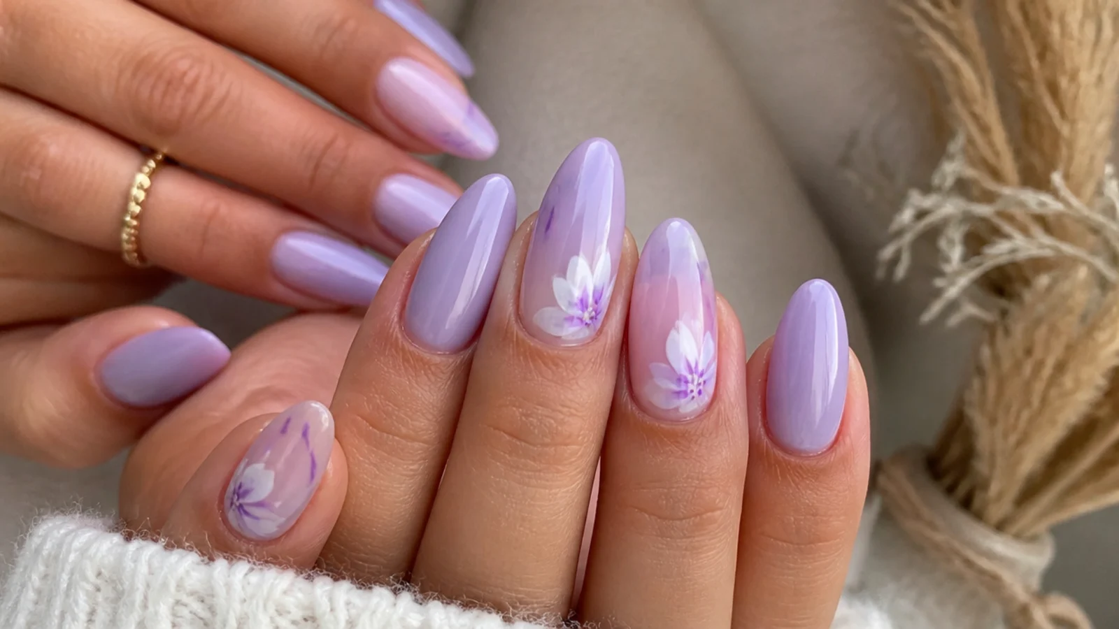 Soft lavender acrylic nails in an almond shape with a milky lilac finish