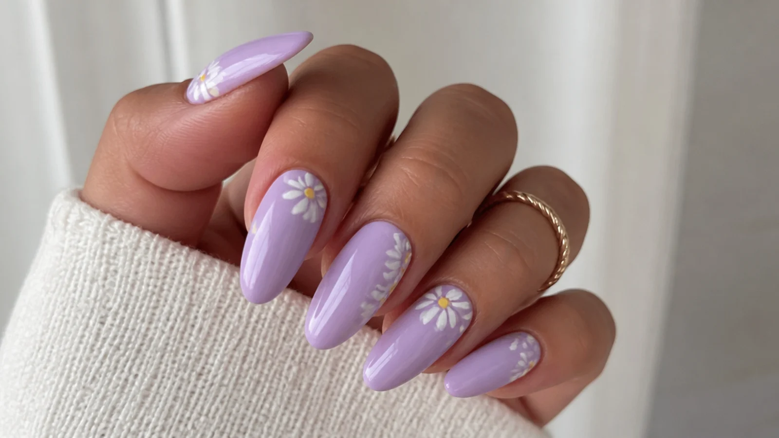 A well-sealed lavender acrylic manicure with cuticle oil for longevity