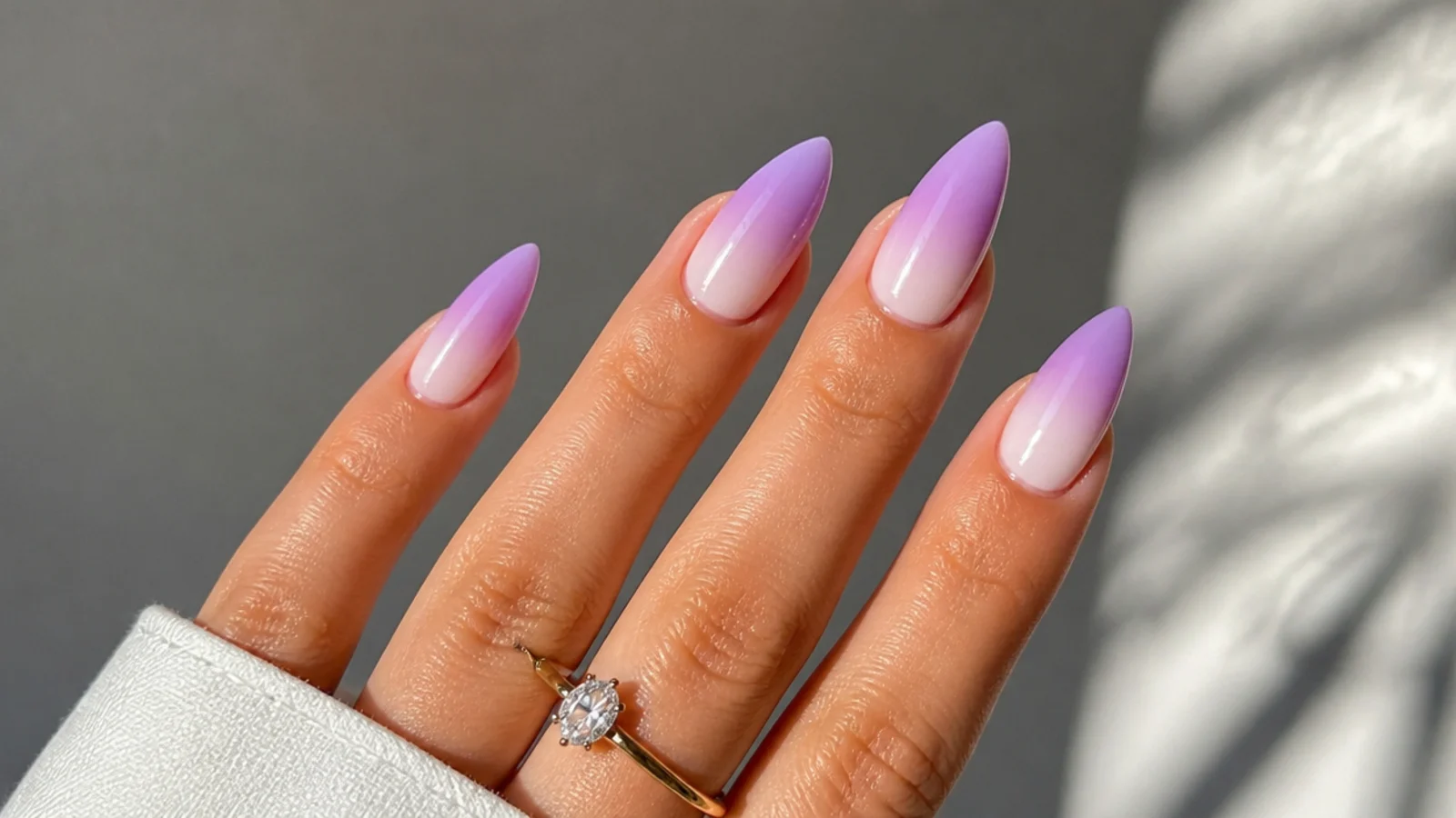 Lavender to white ombre almond nails fading from tip to cuticle