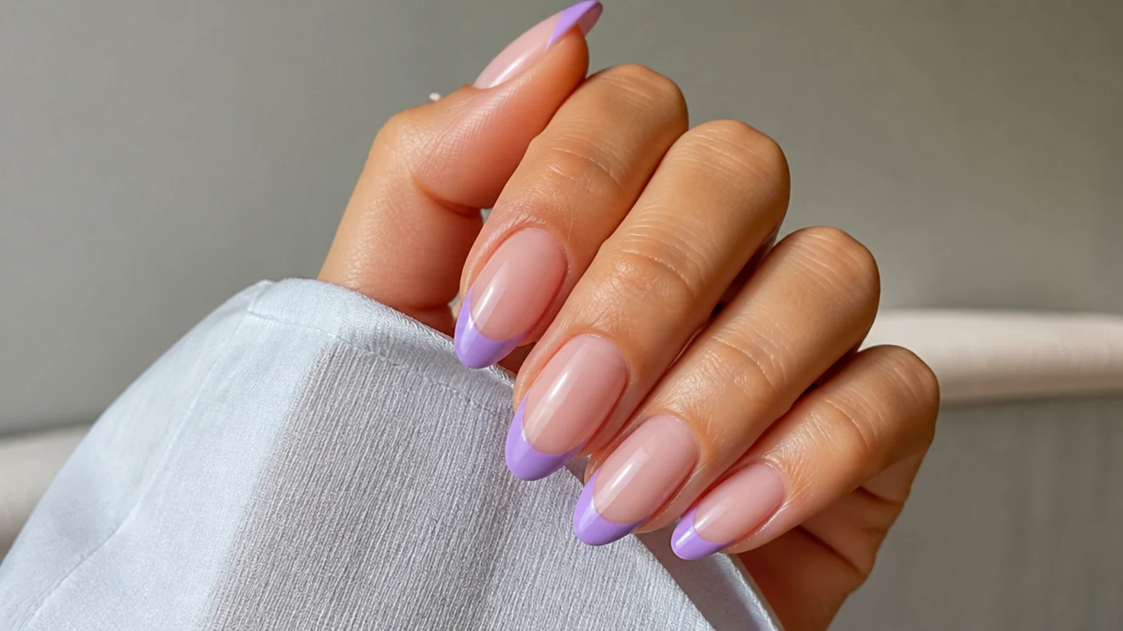 Sheer nude almond nails with crisp lavender French tips