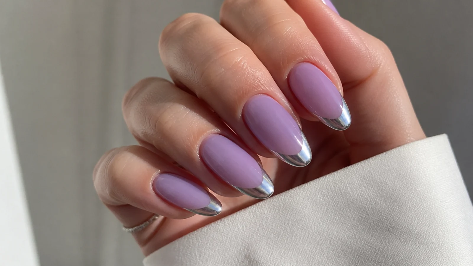 Milky lavender almond nails with silver chrome tips