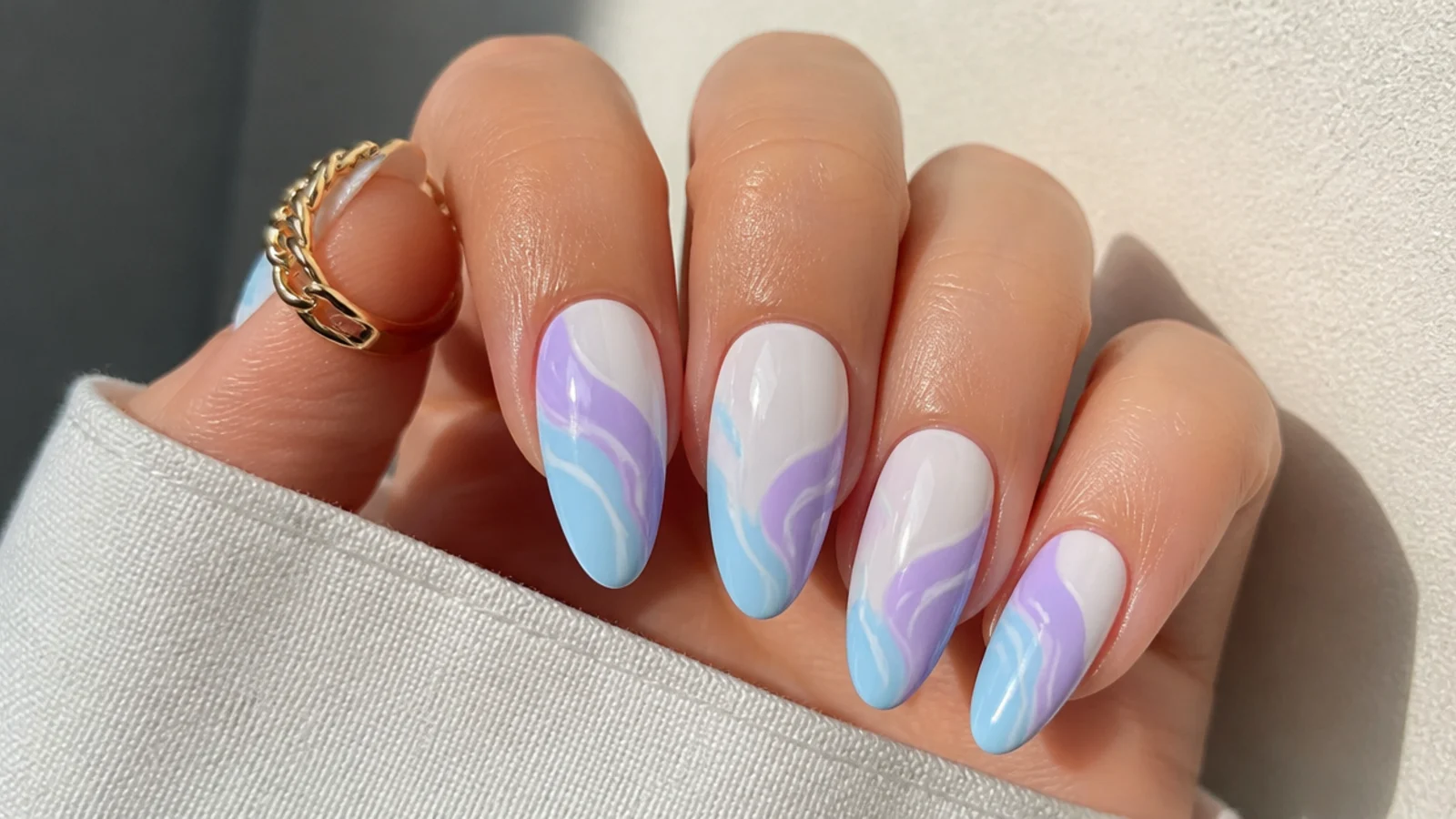 Lavender and baby blue swirl almond nails on a white base